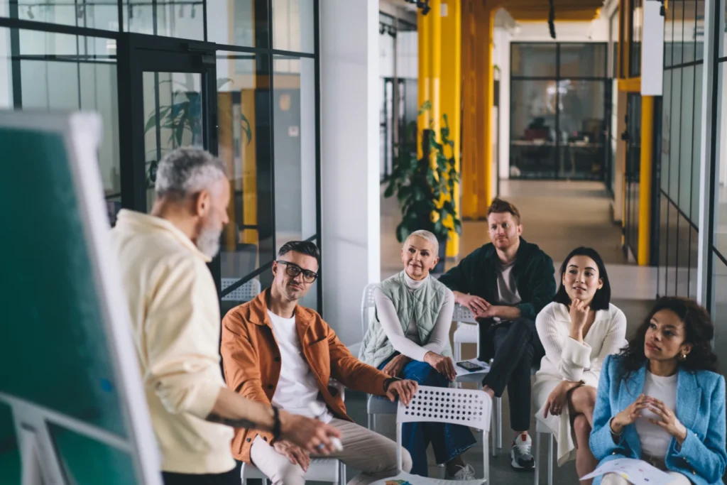 A specialist speaks to a boardroom about employee satisfaction